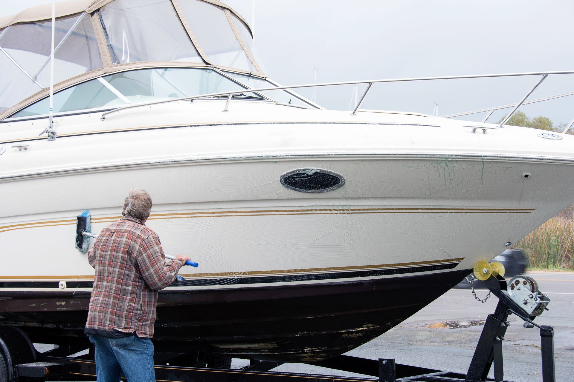 man cleaning boat hull